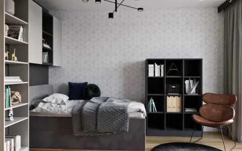 Nowoczesny pokój młodzieżowy dla dziewczyny: inspiracje. Szara tapeta w geometryczne wzory, wygodne łóżko, regały i stylowy fotel.