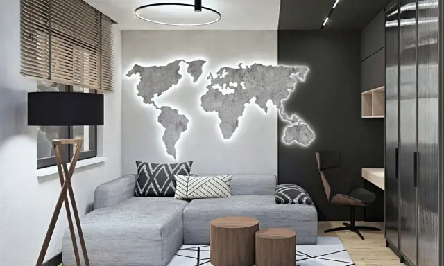 Nowoczesny męski pokój inspiracje: szara kanapa, podświetlana mapa świata na ścianie, drewniane stoliki i biurko.